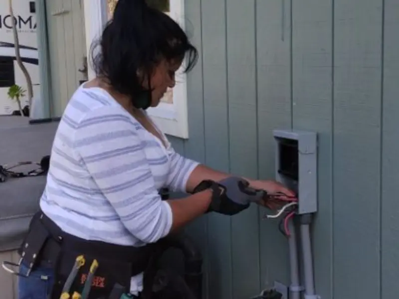 Licensed electrician wiring an exterior subpanel in Rocky Mount